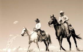 Two Cowboys on Horseback